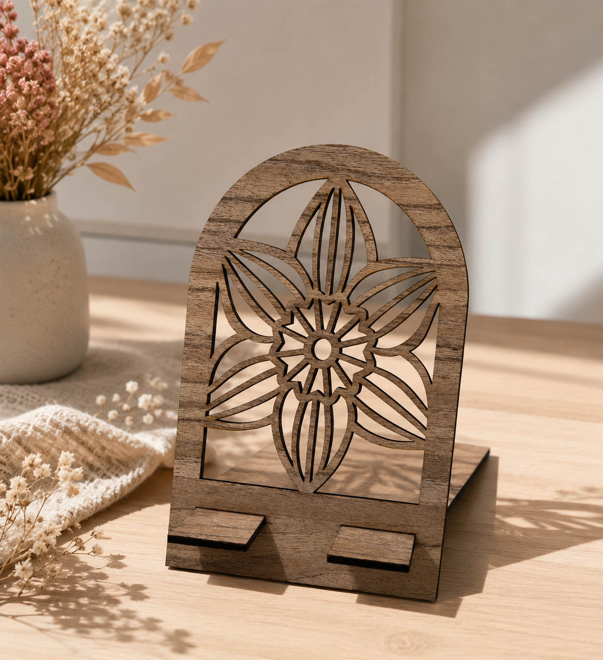 Support téléphone en bois motif fleur géométrique vu de face.